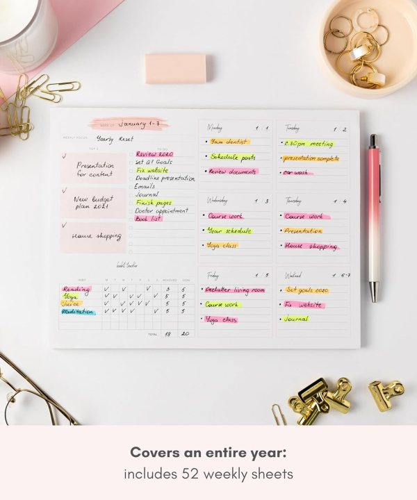 Undated desk calendar with colorful handwritten notes and gold accessories.