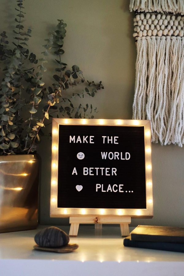 Light-up felt display board with message 'Make the world a better place'.