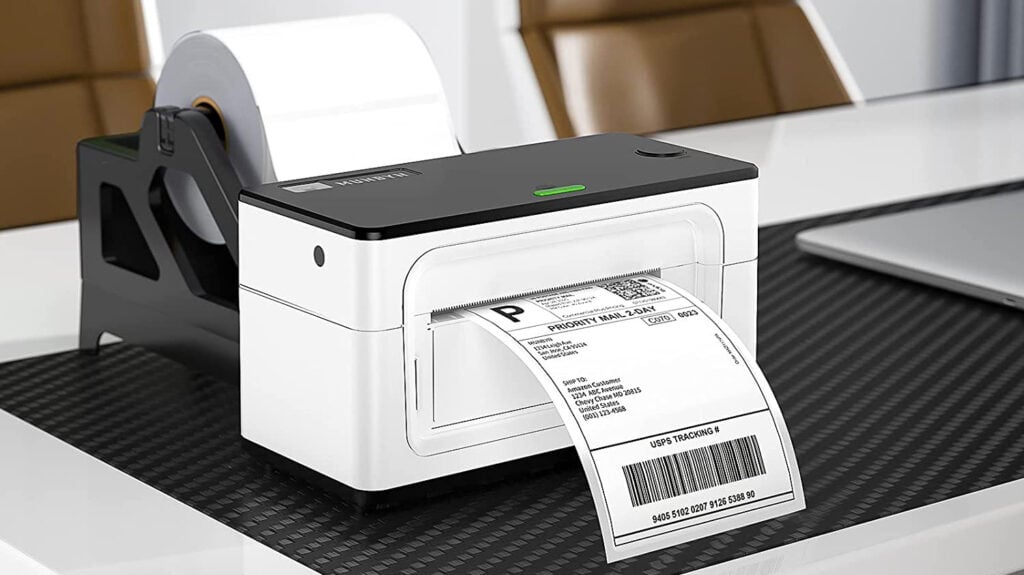 Compact Lambock label printer printing shipping labels on desk.