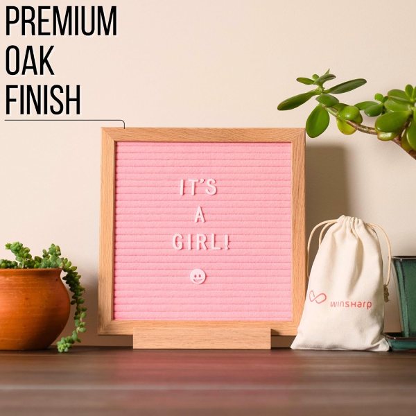 Pink felt letter board with message 'It's a girl!' and smiley face, home decor.