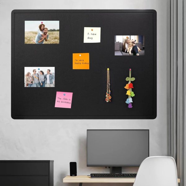 Black felt bulletin board with photos and notes in a modern workspace.