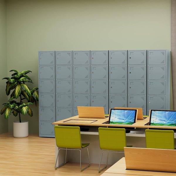 Blue metal storage lockers in an office setting with green chairs and a plant.
