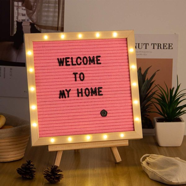 Pink felt letter board with LED lights displaying 'Welcome to my home'.