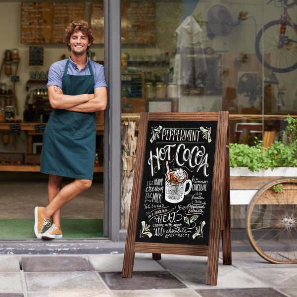 Chalkboard menu sign outside a coffee shop with a barista.