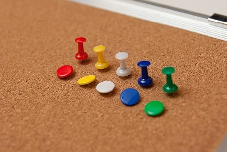 Colorful push pins on corkboard for office or home organization.