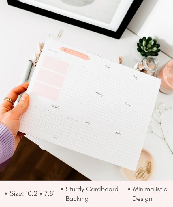 Undated desk planner with weekly layout for tasks and goals.