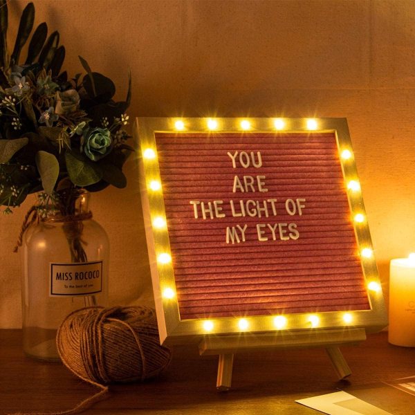 Pink felt letter board with LED lights displaying a romantic message.