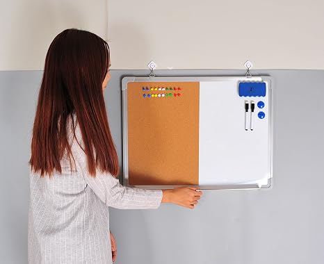 Woman organizing a magnetic corkboard with markers and magnets.