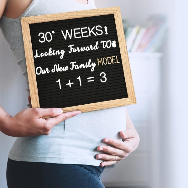 Felt letter board with message about expecting a baby and family model.