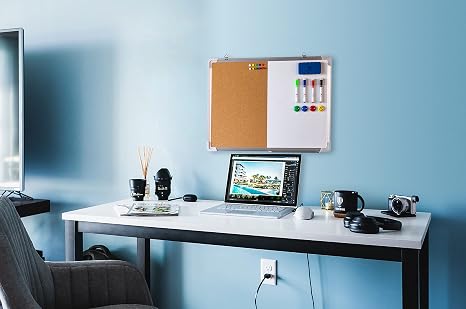Organized office workspace with corkboard, laptop, and accessories.