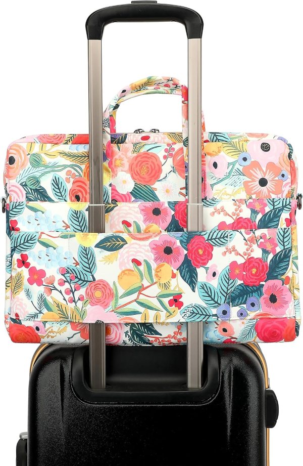 Vibrant floral patterned luggage set on black suitcase handle.